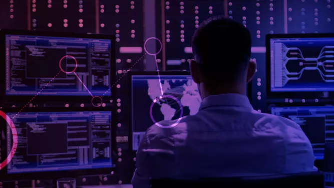 Um homem olhando para uma tela de computador cheia de gráficos