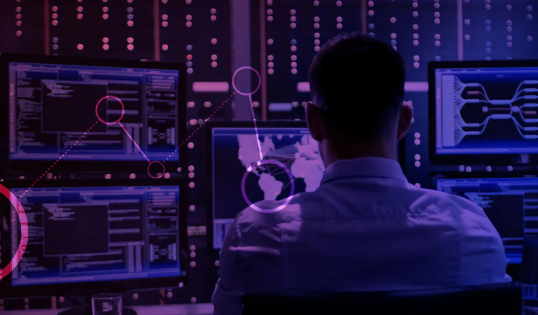 Um homem olhando para uma tela de computador cheia de gráficos